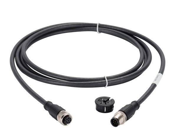 The Cable for PHOENIX Interface by Leybold North America is a coiled black cable with circular connectors at each end, featuring metal couplings. Included with the cable is a small, black plastic piece with a rounded shape and openings. The connectors are equipped with multiple pinholes and pins for device attachment.