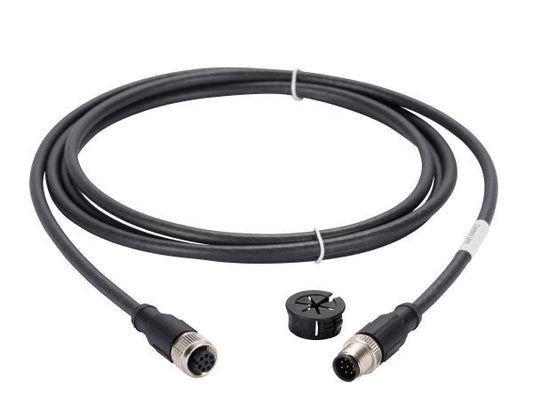 The Cable for PHOENIX Interface by Leybold North America is a coiled black cable with circular connectors at each end, featuring metal couplings. Included with the cable is a small, black plastic piece with a rounded shape and openings. The connectors are equipped with multiple pinholes and pins for device attachment.